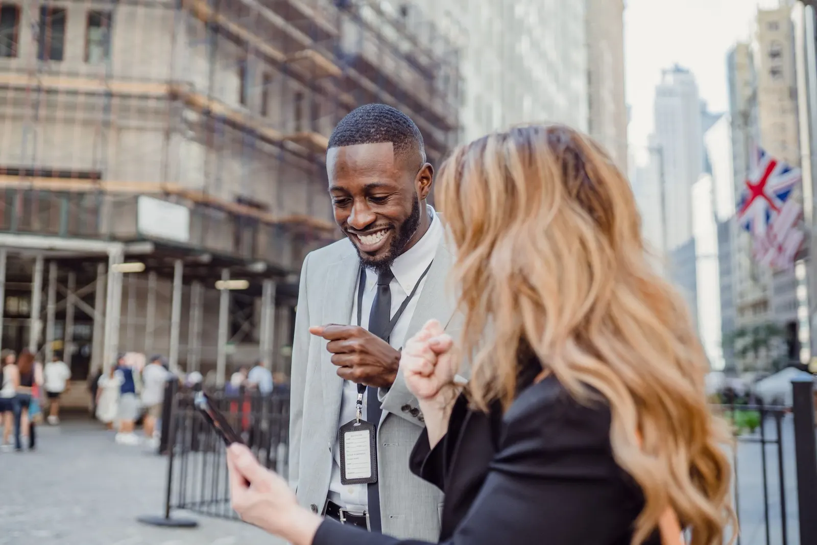 Two professionals chatting on a city street